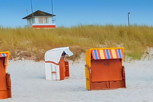 A group of beach chairs - beach chairs on beautiful beach with sand dunes in the background at blue sky - luxury vacation