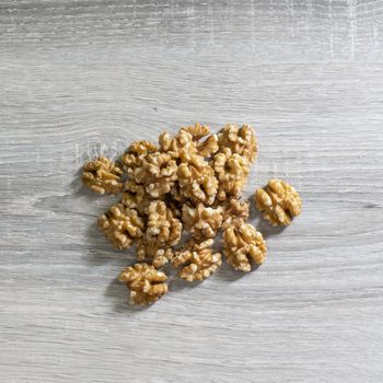 some shelled walnuts on a wooden table