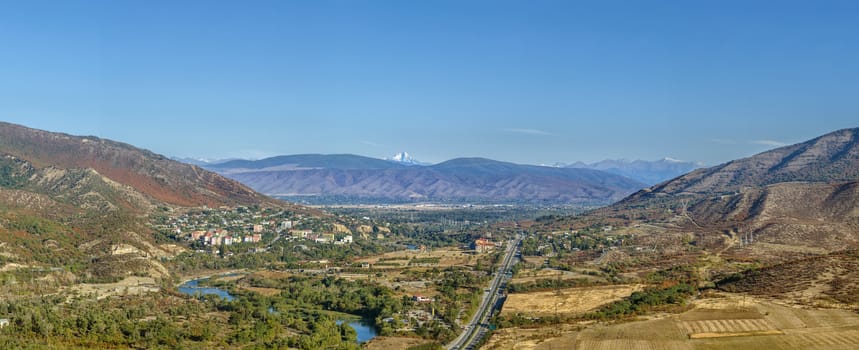 Panoramic view of Aragvi valley from Jvari Monastery hill, Georgia. On the horizon is visible Mount Kazbek
