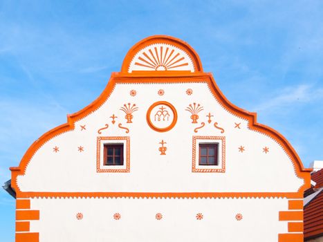 Picturesque gable of old house in Holasovice, small rural village with rustic baroque architecture. Southern Bohemia, Czech Republic. UNESCO heritage site.