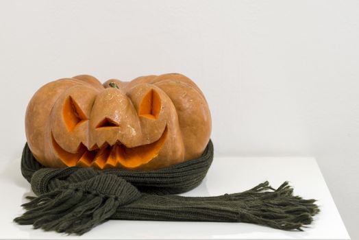 orange halloween pumpkin with carving, crushed and collapsible typology, on a background in nature or white