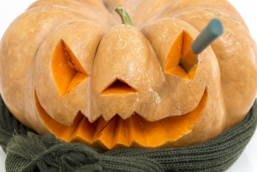 orange halloween pumpkin with carving, crushed and collapsible typology, on a background in nature or white