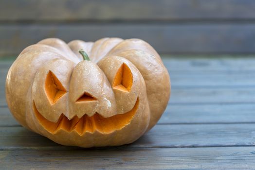 orange halloween pumpkin with carving, crushed and collapsible typology, on a background in nature or white