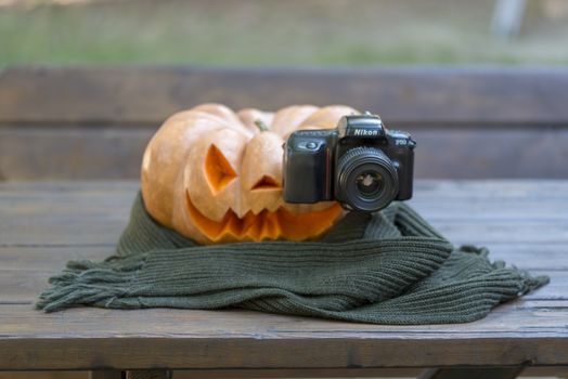 orange halloween pumpkin with carving, crushed and collapsible typology, on a background in nature or white