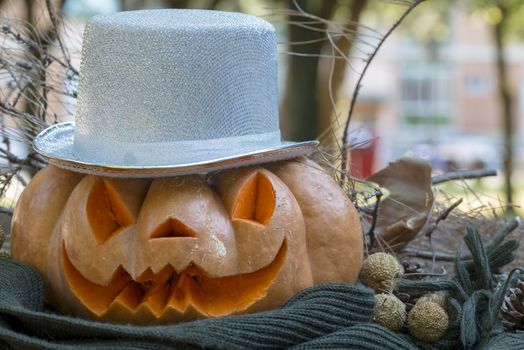 orange halloween pumpkin with carving, crushed and collapsible typology, on a background in nature or white