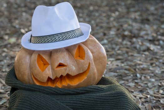 orange halloween pumpkin with carving, crushed and collapsible typology, on a background in nature or white