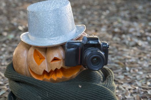 orange halloween pumpkin with carving, crushed and collapsible typology, on a background in nature or white