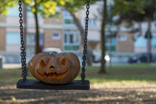 orange halloween pumpkin with carving, crushed and collapsible typology, on a background in nature or white