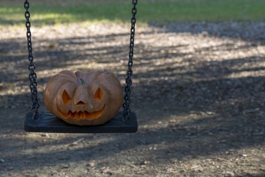 orange halloween pumpkin with carving, crushed and collapsible typology, on a background in nature or white