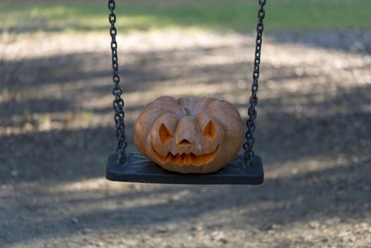 orange halloween pumpkin with carving, crushed and collapsible typology, on a background in nature or white