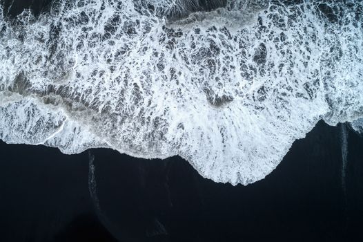 Aerial view of Black sand beach and ocean waves in Iceland.