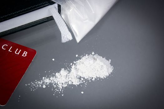 Drug cocaine in a bag and poured on a table