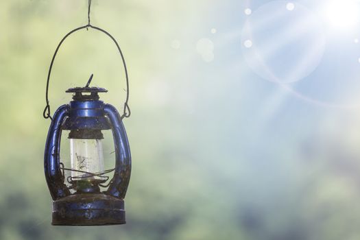 Old Rustic Kerosene Lamp, Old Oil Lamp with Spider Web Isolated on Natural Background