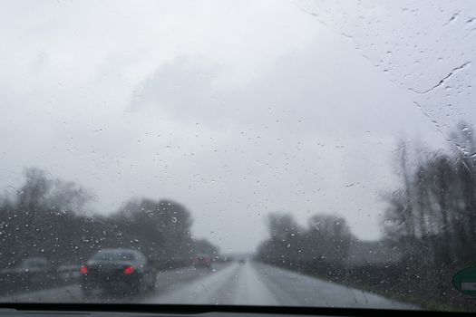 Traffic jam on rainy bad day, raindrops on car window