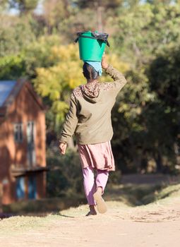 African woman transport, carrying for many miles, Madagascar