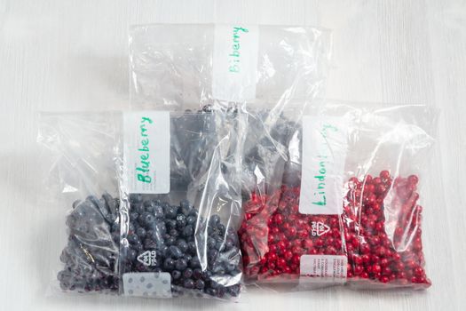 Berries laid out on a bags and prepared for freezing and storage, top view.