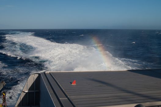 Back of a ship, wake and rainbow. Atlantic Ocean. Canary Islands. Spain.