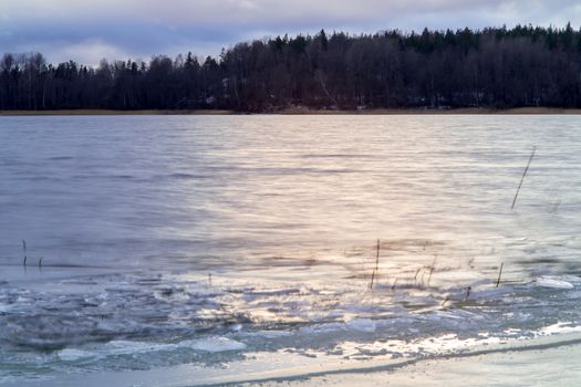 first ice on the lake in late autumn. Winter Coming Landscape.