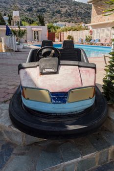 Scooter carnival car in front of a swimming pool in the city of Stalis in Crete