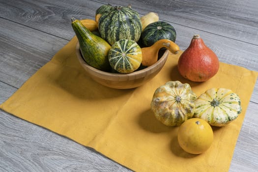 Some small pumpkins  on a wooden table in the autumn