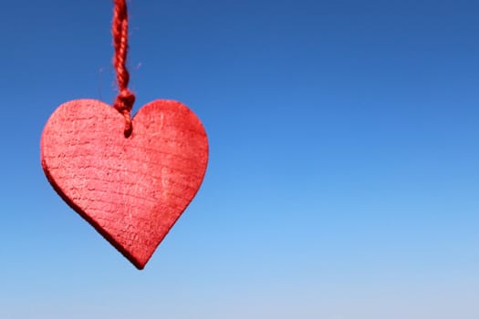 The picture shows a red heart on the blue sky.