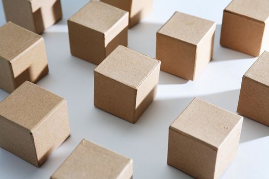 Set of cardboard cubes on white background with light and shadows