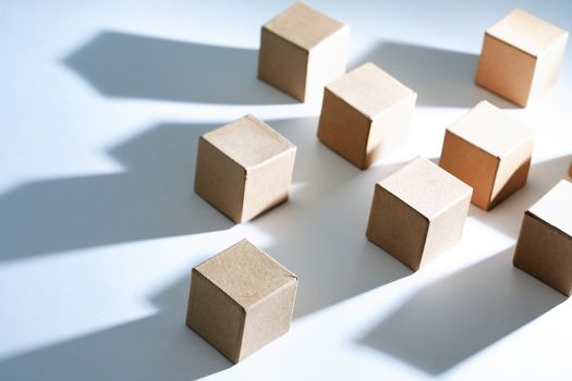 Set of cardboard cubes on white background with light and shadows