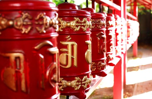 Red Buddhist prayer drums closeup background