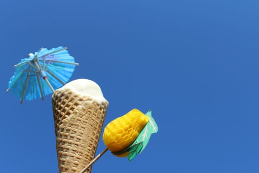 The picture shows an ice cream cone in front of the blue sky.