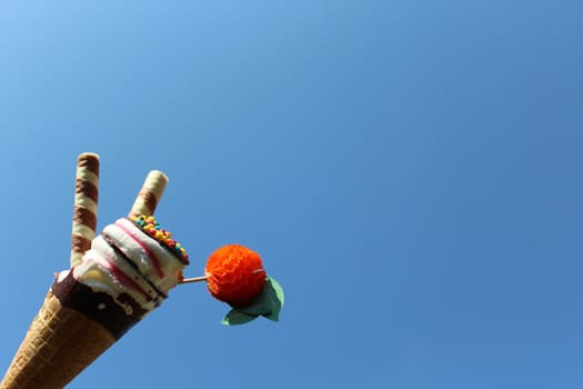 The picture shows an ice cream cone in front of the blue sky.