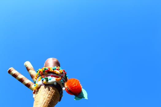 The picture shows an ice cream cone in front of the blue sky.