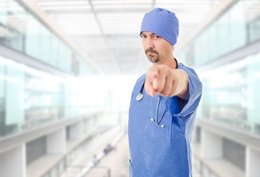 male doctor pointing at the hospital