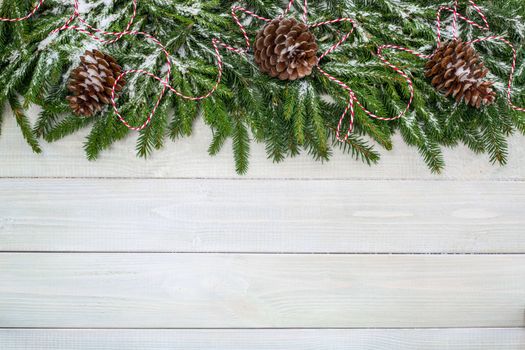 Christmas background with fir branches and snow on white toned natural wooden plank background texture provence style for copy space for text