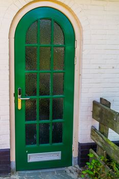Modern green door, building entrance, small window pattern design, architecture background