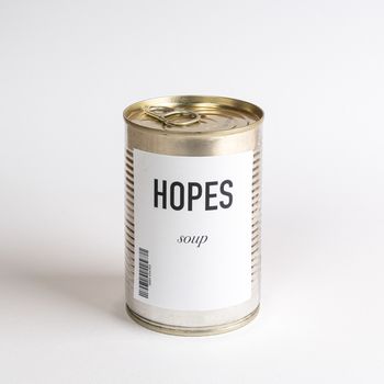 a jar containing hopes concept soup on a white surface