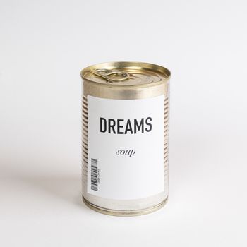 a jar containing dreams soup on a white surface