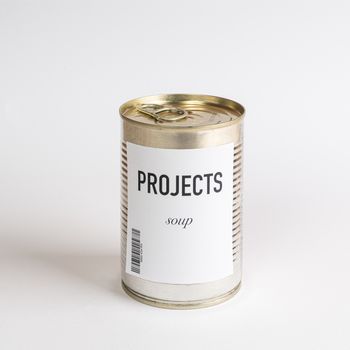 a jar containing projects concept soup on a white surface