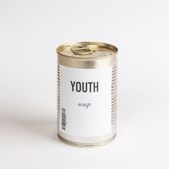 a jar containing youth concept soup on a white surface