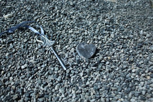 The picture shows a key and a heart of stone.