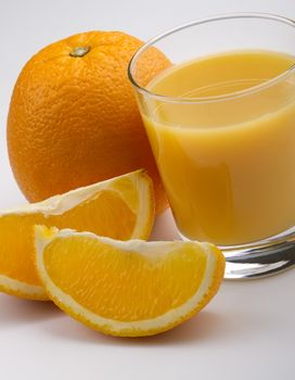  a glass of orange juice with fruits