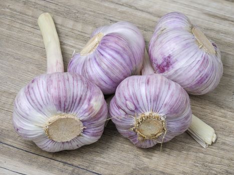 Fresh ripe garlic on wooden background. Close up view.