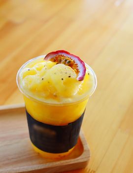 Healthy drink of passion fruit smoothies on wooden background.