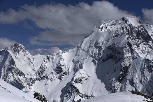 View of Snow Mountain Range Landscape with Blue Sky. Russia, Caucasus.