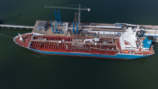 ship going in to Harbor Ventspils Latvia Aerial view of countryside drone top view