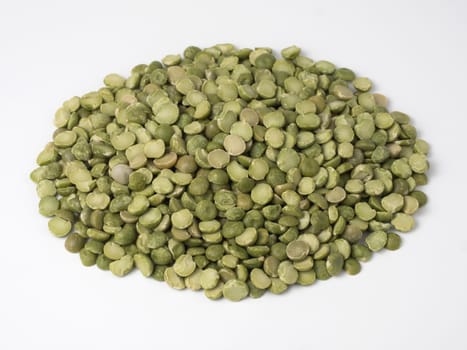 Green dry peas in a pile isolated on a white background.