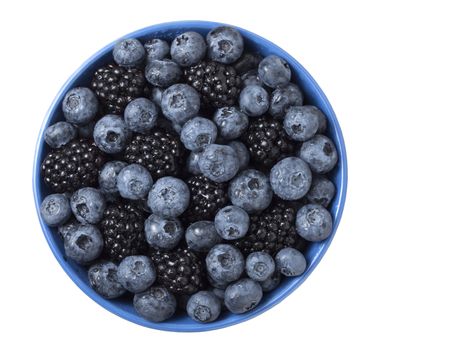 Forest berries (blueberry,bramble) in a ceramic blue  bowl. Top view. 
