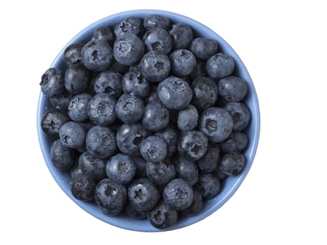 Bowl full of fresh ripe blueberries on white background.  Top view, close up.