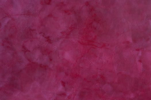 painted,  layered surface of the wall in magenta and red  tones