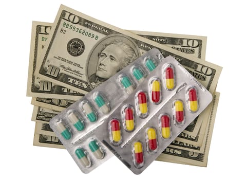 tablets in packs  against dollar banknotes, isolated on white