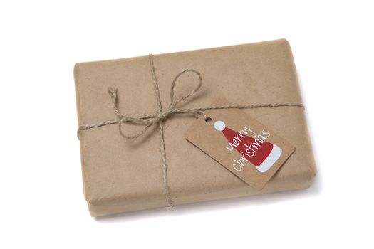 Christmas gift box wrapped in kraft paper. Isolated on white background